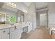En suite bathroom features dual vanities, tiled floors, and glass enclosed walk-in shower at 2165 Parkview Nw Run, Atlanta, GA 30318
