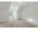 Empty bedroom showcasing sloped ceilings, a window, and wall-to-wall carpeting at 2165 Parkview Nw Run, Atlanta, GA 30318