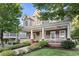 Beautiful two-story home showcasing a spacious front porch, lush landscaping and brick accents at 2165 Parkview Nw Run, Atlanta, GA 30318