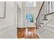 Bright foyer with hardwood floors, detailed trim, staircase, and transom window over the front door at 2165 Parkview Nw Run, Atlanta, GA 30318
