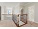 Upstairs hallway features decorative iron railing overlooking stairs and adjacent rooms at 2165 Parkview Nw Run, Atlanta, GA 30318