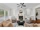 Bright living room features a cozy fireplace, built-in shelving, and comfortable seating at 2165 Parkview Nw Run, Atlanta, GA 30318