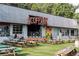 Scofflaw Brewery's outdoor area featuring picnic tables, greenery, and vibrant art, creating a relaxing community gathering space at 2165 Parkview Nw Run, Atlanta, GA 30318