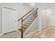 Elegant staircase featuring wooden steps, dark iron balusters, and wood-look floors at 2165 Parkview Nw Run, Atlanta, GA 30318