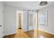 Bright bedroom featuring hardwood floors, access to closet, and a sliding barn door to the ensuite at 2855 Briarlake Ne Rd, Atlanta, GA 30345