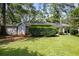 Landscaped backyard view of this well-maintained single story home with mature trees and green grass lawn at 2855 Briarlake Ne Rd, Atlanta, GA 30345