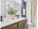 Bathroom features a double vanity with granite countertop, modern fixtures, and a shower with curtain at 4885 Rosarian Drive, Cumming, GA 30040