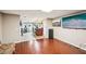Open basement layout featuring a bar with stools, a TV, a sofa and tiled/wood flooring at 1285 Willow Park Way, Cumming, GA 30041