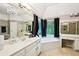 The primary bathroom features a large tub, double sinks and vanity with a chandelier at 1285 Willow Park Way, Cumming, GA 30041