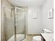Bathroom with a walk-in shower featuring glass doors, and neutral-toned tiles at 1285 Willow Park Way, Cumming, GA 30041