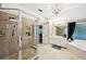 A luxury bathroom featuring a walk-in shower, jetted tub and bright lighting at 1285 Willow Park Way, Cumming, GA 30041