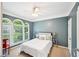 A relaxing bedroom with light blue walls, large windows, and a ceiling fan at 1285 Willow Park Way, Cumming, GA 30041