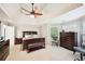 Large bedroom with dark wood furniture, ceiling fan, and view of the yard at 1285 Willow Park Way, Cumming, GA 30041