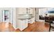 A dining area with white cabinetry, black countertops, and beautiful wood floors at 1285 Willow Park Way, Cumming, GA 30041