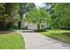 Beautiful home with a two-car garage, manicured lawn, and mature trees along a paved driveway at 1285 Willow Park Way, Cumming, GA 30041
