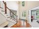Elegant foyer featuring hardwood floors, staircase with white banister, and a view of the front door with glass panels at 1285 Willow Park Way, Cumming, GA 30041