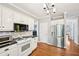 Bright kitchen with white cabinets, stainless steel appliances, and hardwood floors at 1285 Willow Park Way, Cumming, GA 30041