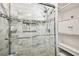 Shower features a glass door, marble tiling, a built-in niche, and metal shelving at 1285 Willow Park Way, Cumming, GA 30041