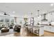 Open-concept living room and kitchen with island seating, stainless appliances, and views of the backyard at 4660 Rosarian Drive, Cumming, GA 30040