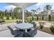 Inviting outdoor patio with a dining table, seating, and a fire pit, perfect for entertaining and relaxing outdoors at 4660 Rosarian Drive, Cumming, GA 30040