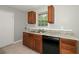Kitchen featuring a double basin sink, black appliances, and oak cabinets with granite countertops at 1112 Evelyn Drive Dr, Forest Park, GA 30297