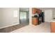 A kitchen with a view of the living room offers tiled floors, black appliances, and wooden cabinets at 1112 Evelyn Drive Dr, Forest Park, GA 30297
