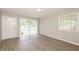 Bright living room with wood floors, neutral walls, and a large window with blinds at 1112 Evelyn Drive Dr, Forest Park, GA 30297