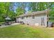 Exterior of home featuring backyard with patio dining, barbeque, storage, and grass at 269 Terrydale Se Dr, Marietta, GA 30067