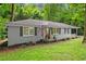 Charming single-story home featuring a classic brick facade, white picket fence, and an inviting carport at 269 Terrydale Se Dr, Marietta, GA 30067