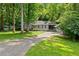 Landscaped front yard with a long driveway leading to a charming home surrounded by lush trees at 269 Terrydale Se Dr, Marietta, GA 30067