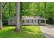 Charming single-story home with a well-manicured lawn, a white picket fence, and a convenient carport at 269 Terrydale Se Dr, Marietta, GA 30067