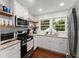 Well-lit kitchen featuring stainless steel appliances, granite countertops, and light wood shelving at 269 Terrydale Se Dr, Marietta, GA 30067