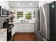 Bright kitchen with stainless steel refrigerator, gas range and granite countertops at 269 Terrydale Se Dr, Marietta, GA 30067