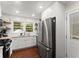 Charming kitchen features a stainless steel fridge, bright white cabinets, and granite countertops at 269 Terrydale Se Dr, Marietta, GA 30067