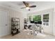 Bright home office featuring a ceiling fan, desk with dual monitors, and natural light from the large window at 269 Terrydale Se Dr, Marietta, GA 30067