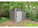Outdoor backyard storage shed with white sliding door surrounded by lush greenery at 269 Terrydale Se Dr, Marietta, GA 30067