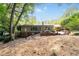 The back of the home features access to the brick patio and is surrounded by mature trees at 2917 Rockingham Nw Dr, Atlanta, GA 30327