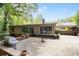 Backyard brick patio with a grill, fire pit and access to the home and backyard at 2917 Rockingham Nw Dr, Atlanta, GA 30327