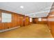Large basement with wood paneling, multiple windows, and carpet flooring offers versatile space for various needs at 2917 Rockingham Nw Dr, Atlanta, GA 30327