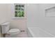 Clean, white bathroom with bathtub and tiled walls, offering a refreshing and modern design at 2917 Rockingham Nw Dr, Atlanta, GA 30327