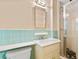Vintage bathroom featuring blue tiled walls and a shower with glass door that add charm and functionality at 2917 Rockingham Nw Dr, Atlanta, GA 30327
