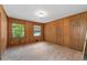 Comfortable bedroom featuring wood paneling, dual windows, and closet space at 2917 Rockingham Nw Dr, Atlanta, GA 30327