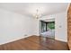 Dining Room with hardwood floors, brick accent wall and french doors to the sunroom at 2917 Rockingham Nw Dr, Atlanta, GA 30327