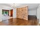 Dining room featuring hardwood floors, brick wall, and access to sunroom at 2917 Rockingham Nw Dr, Atlanta, GA 30327