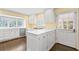 Well lit kitchen includes gas range cooktop, stainless dishwasher, and white cabinets at 2917 Rockingham Nw Dr, Atlanta, GA 30327