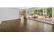Open-concept living room featuring hardwood floors and large windows showcasing outdoor greenery at 2917 Rockingham Nw Dr, Atlanta, GA 30327