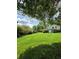 Large grassy backyard offering ample space for outdoor activities, bordered by mature trees and greenery at 3400 Elm Creek Nw Dr, Marietta, GA 30064