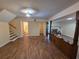Cozy living area with hardwood floors, a fireplace, and a staircase leading to the upper level at 3400 Elm Creek Nw Dr, Marietta, GA 30064
