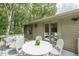 Outdoor dining set on a covered porch with cushioned seating at 4023 Anvil Block Rd, Ellenwood, GA 30294