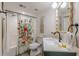 Cozy bathroom with a floral shower curtain, modern vanity, and decorative mirror at 4023 Anvil Block Rd, Ellenwood, GA 30294
